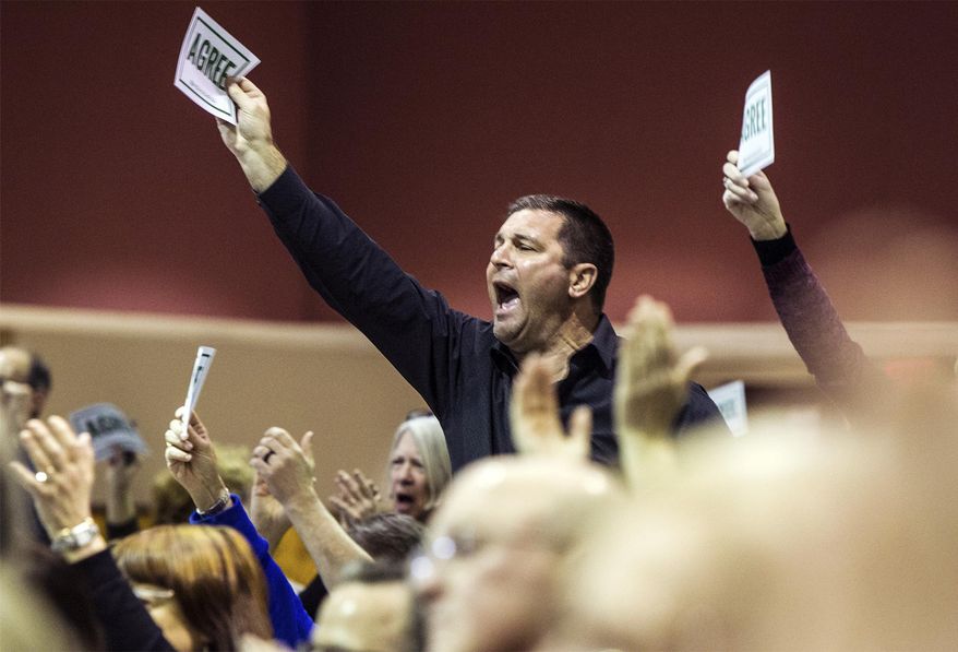 Audience members react during a town hall event hosted by Republican U.S. Rep. Scott Perry at a Junior High School in Red Lion, Pa., on Saturday, March 18, 2017. Perry is the first Pennsylvania Republican member of Congress to hold a live town hall since Trump took office. Submitted questions are being picked and read by the school district's superintendent. (Sean Simmers/PennLive.com via AP)