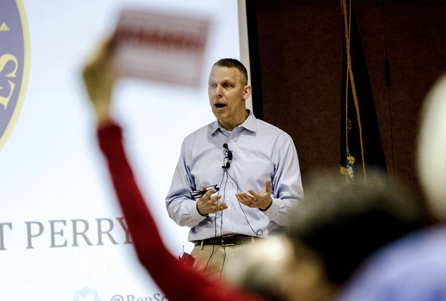 Republican U.S. Rep. Scott Perry holds a town hall event at a Junior High School in Red Lion, Pa., on Saturday, March 18, 2017. Perry is the first Pennsylvania Republican member of Congress to hold a live town hall since Trump took office. Submitted questions are being picked and read by the school district's superintendent. (Sean Simmers/PennLive.com via AP)