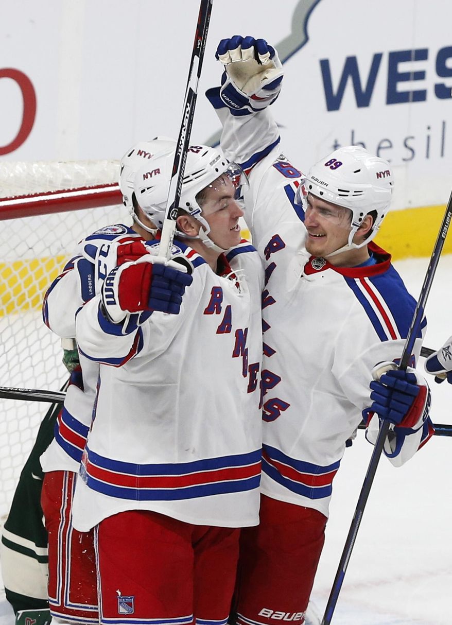New York Rangers&#39; Jimmy Vesey, left, is congratulated by Pavel Buchnevich after his goal against Minnesota Wild goalie Devan Dubnyk during the second period of an NHL hockey game Saturday, March 18, 2017, in St. Paul, Minn. (AP Photo/Jim Mone)