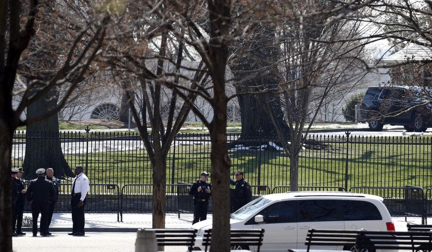 US Secret Service officers stand in the cordoned off area on Pennsylvania Avenue after a security incident near the fence of the White House in Washington, Saturday, March 18, 2017. President Trump was not at the White House at the time of the incident. (AP Photo/Alex Brandon)