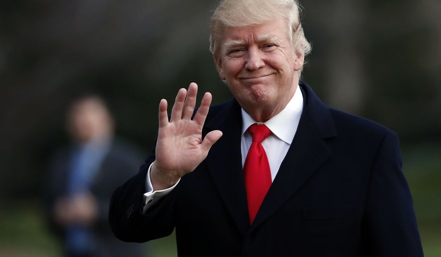 President Donald Trump waves as he walks to the White House after arriving on Marine One, Sunday, March 19, 2017, in Washington. Trump is returning from a trip to his Mar-a-Lago estate in Palm Beach, Fla. (AP Photo/Alex Brandon)