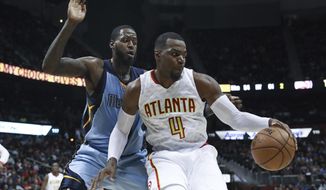 Atlanta Hawks forward Paul Millsap (4) controls the ball while being defended by Memphis Grizzlies forward JaMychal Green (0) during the second half of am NBA game, Thursday, March 16, 2017, in Atlanta. The Grizzlies defeated the Hawks 103-91. (AP Photo/Branden Camp)