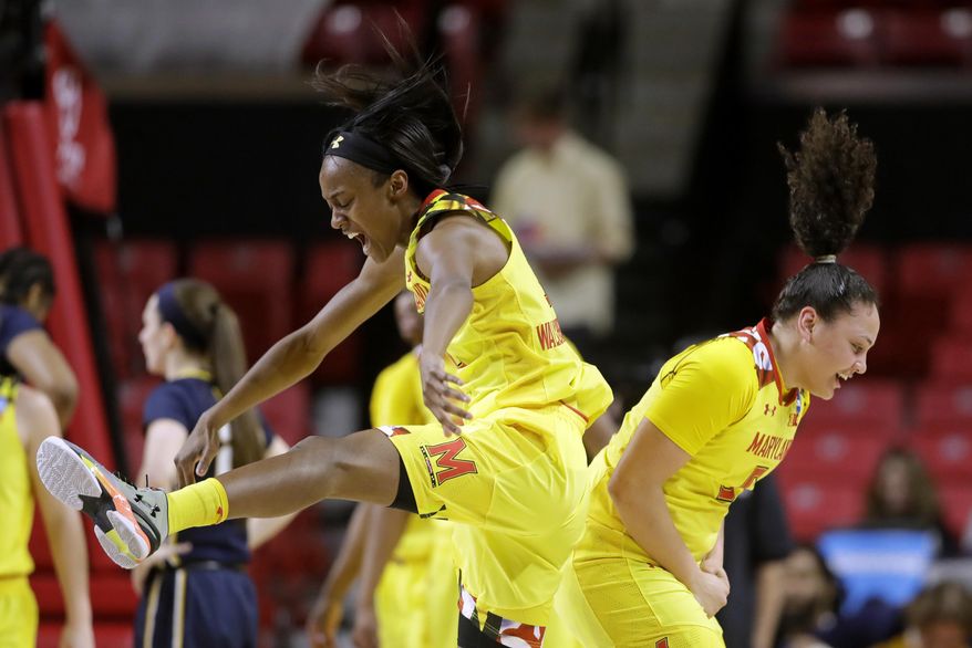 Maryland guards Shatori Walker-Kimbrough, left, and Destiny Slocum celebrate after West Virginia called a timeout in the first half of a second-round game in the women's NCAA college basketball tournament in College Park, Md., Sunday, March 19, 2017. (AP Photo/Patrick Semansky)