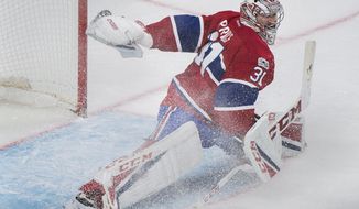 Montreal Canadiens goaltender Carey Price makes a save against the Ottawa Senators during the second period of an NHL hockey game in Montreal, Sunday, March 19, 2017. (Graham Hughes/The Canadian Press via AP)
