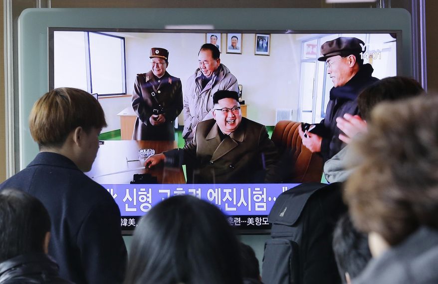 People watch a TV news program showing an image, published in North Korea's Rodong Sinmun newspaper, of North Korean leader Kim Jong Un at the country's Sohae launch site, at Seoul Railway station in Seoul, South Korea, Sunday, March 19, 2017. North Korea has conducted a ground test of a new type of high-thrust rocket engine that leader Kim Jong Un is calling a revolutionary breakthrough for the country's space program. (AP Photo/Ahn Young-joon)