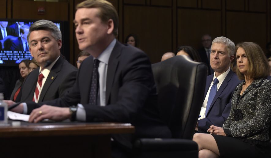 Supreme Court Justice nominee Neil Gorsuch and his wife Marie Louise, listen as Sen. Michael Bennet, D-Colo., second from left, accompanied by Sen. Cory Gardner, R-Colo., introduces Gorsuch during opening statements on Capitol Hill in Washington, Monday, March 20, 2017, at Gorsuch's confirmation hearing before the Senate Judiciary Committee. (AP Photo/Susan Walsh)