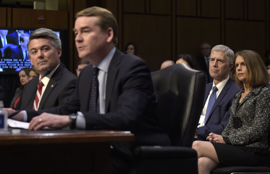 Supreme Court Justice nominee Neil Gorsuch and his wife Marie Louise, listen as Sen. Michael Bennet, D-Colo., second from left, accompanied by Sen. Cory Gardner, R-Colo., introduces Gorsuch during opening statements on Capitol Hill in Washington, Monday, March 20, 2017, at Gorsuch's confirmation hearing before the Senate Judiciary Committee. (AP Photo/Susan Walsh)