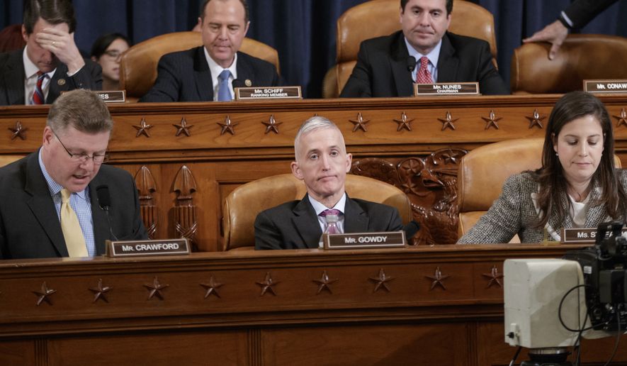 Members of the House Permanent Select Committee on Intelligence near the end of five hours of questioning of FBI Director James B. Comey and National Security Agency Director Adm. Michael Rogers on allegations of Russian interference in the 2016 U.S. presidential election, on Capitol Hill in Washington, in this Monday, March 20, 2017, file photo. From left on bottom row, Rep. Rick Crawford, R-Ark., Rep. Trey Gowdy, R-S.C., Rep. Elise Stefanik, R-N.Y., and from left on top row, Rep. Jim Himes, D-Conn., Rep. Adam Schiff, D-Calif., the ranking member, and Chairman Rep. Devin Nunes, R-Calif. (AP Photo/J. Scott Applewhite) ** FILE **