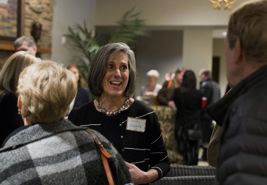 In this Saturday, March 18, 2017, photo, Bob Eleveld's daughter Wendy Ahlrichs greets guests at Eleveld's "celebration of life" at Thousand Oaks Golf Club in Grand Rapids, Mich. Bob Eleveld, a Michigan lawyer and Republican activist, has died, a day after hundreds of people responded to his published invitation to attend the open house to celebrate his life. Eleveld died Sunday at age 80. (Mike Clark/The Grand Rapids Press via AP)