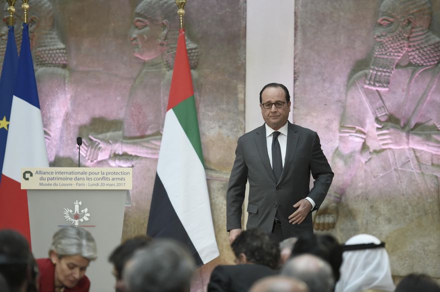 French President Francois Hollande leaves the podium after delivering a speech as part of an International Donors' Conference for the Protection of Heritage in Armed Conflict at the Louvre Museum in Paris, France, Monday, March 20, 2017. France is trying to raise tens of millions of dollars from international donors to protect cultural heritage sites threatened by war and the kind of destruction carried out by Islamic State militants. (Stephane de Sakutin/Pool Photo via AP)