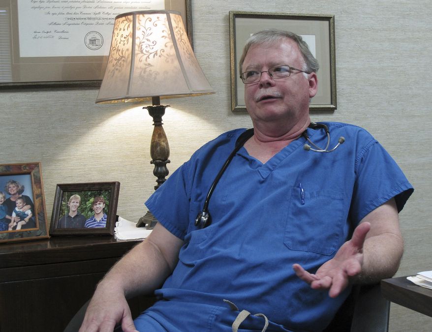 In this Thursday, March 9, 2017 photo, Dr. Kyle Parks sits in his office outside Evans Memorial Hospital in Claxton, Ga. Parks works as the lone general surgeon at the hospital, which has struggled financially in recent years like many other rural U.S. hospitals. But the hospital can’t and won’t turn away the uninsured, federal law prohibits it in emergencies. Recently, Parks performed an urgent gallbladder operation on an uninsured woman. “It is what we’ve always done, we take care of people, payer or no payer,” Parks said. (AP Photo/Russ Bynum)