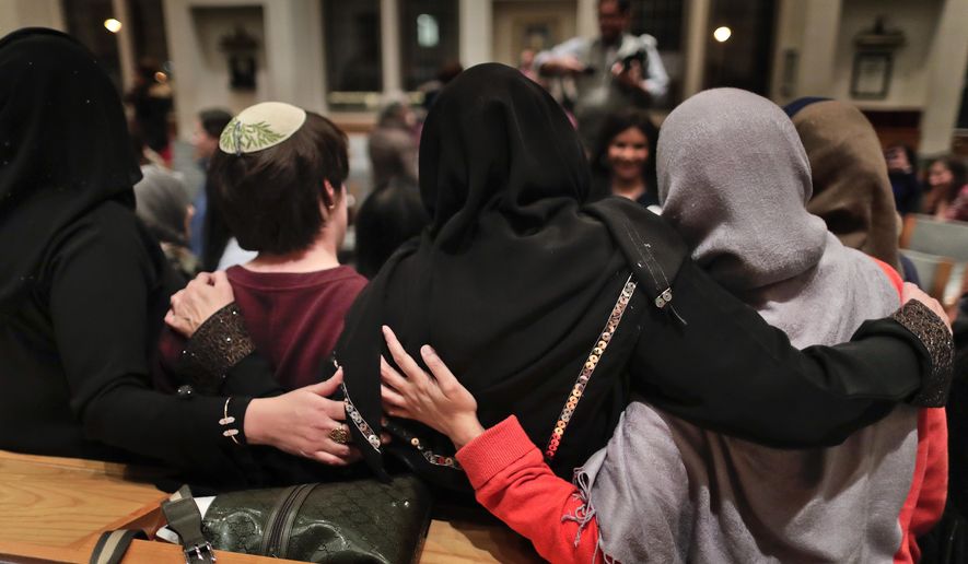 Members of the Sisterhood Salaam Shalom, gather for a group photo after a unity vigil held at the Jewish Theological Seminary in New York. The Sisterhood of Salaam Shalom, a national organization that brings together Muslim and Jewish women, organized the gathering as part of the organization&#39;s response to President Donald Trump&#39;s travel ban. (AP Photo/Julie Jacobson)