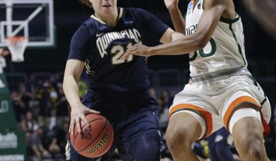 Quinnipiac&#39;s Jen Fay (21) drives to the basket as Miami&#39;s Erykah Davenport (30) defends during the first half of a second round game in the NCAA women&#39;s college basketball tournament, Monday, March 20, 2017, in Coral Gables, Fla. (AP Photo/Lynne Sladky)
