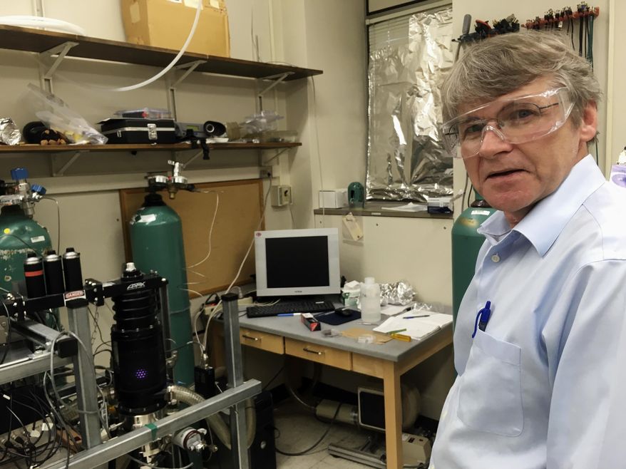 In this March 6, 2017, photo, University of Wisconsin-Madison chemistry professor Robert Hamers shows off equipment in one of his campus labs in Madison, Wis. Wisconsin Gov. Scott Walker has joined a national conservative push to get professors to do more teaching and less research. (AP Photo/Todd Richmond)