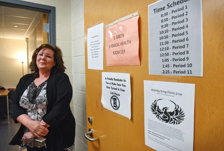 In this Friday, March 10, 2017, photo, Shelly Green, pauses near the entrance to the recovery school during an interview at McKinley Area Learning Center in Waite Park, Minn. Green a chemical health counselor, helped design McKinley Recovery School to be isolated from other parts of the main school: The sober school students start at a time different from other students, must be escorted in the hallways and stay in the classroom while teachers rotate in and out. (Dave Schwarz/St. Cloud Times via AP)