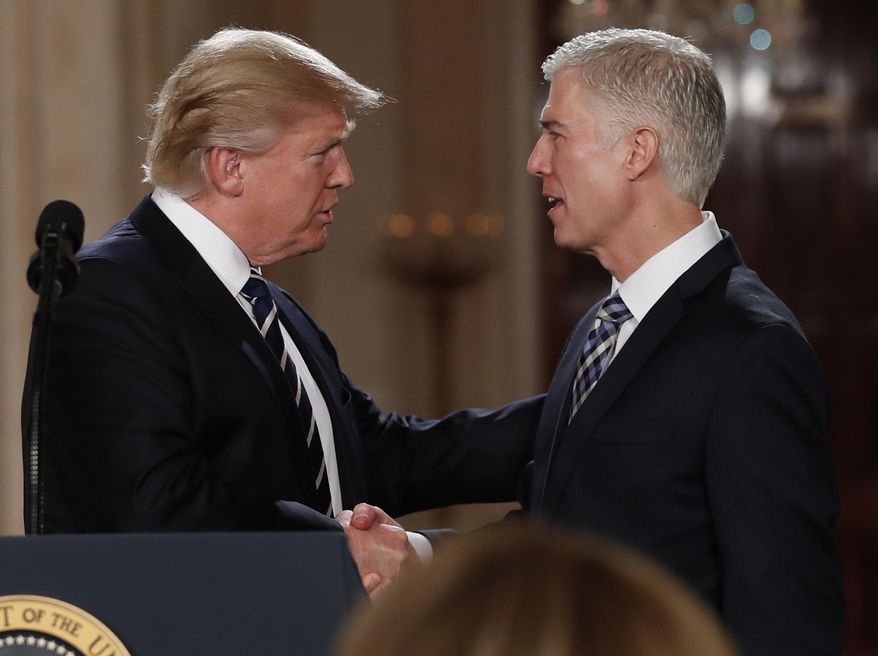 FILE - In this Jan. 31, 2017, file photo, President Donald Trump shakes hands with 10th U.S. Circuit Court of Appeals Judge Neil Gorsuch, his choice for Supreme Court Justice in the East Room of the White House in Washington.  Gorsuch is roundly described by colleagues and friends as a silver-haired combination of wicked smarts, down-to-earth modesty, disarming warmth and careful deliberation. His critics largely agree with that view of the self-described “workaday judge” in polyester robes. Even so, they’re not sure it’s enough to warrant giving him a spot on the court. (AP Photo/Carolyn Kaster, file)