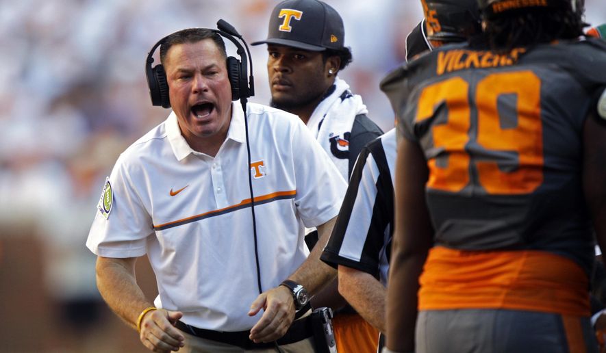 FILE - In this Sept. 24, 2016 file photo, Tennessee head coach Butch Jones yells to his players during an NCAA college football game against Florida in Knoxville, Tenn. Tennessee won 38-28. Jones has overhauled his coaching staff as the Volunteers get ready for a season in which they must find a new starting quarterback and replace their all-time sack leader. (AP Photo/Wade Payne, File)