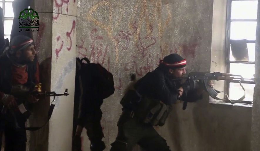 This frame grab from video provided on Tuesday March 21, 2017, by Ahrar al-Sham, Syrian militant group outlet that is consistent with independent AP reporting, shows fighters from Ahrar al-Sham militant group fire during a battle against the Syrian government forces, in an eastern neighborhood of Damascus, Syria. Syrian government forces launched a counter-attack against rebels in Damascus on Tuesday, following a rebel suicide car bombing and another insurgent assault earlier in the day in the country&#39;s capital, media reports said. (Ahrar al-Sham, Syrian militant group, via AP)