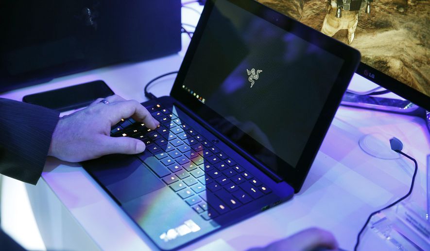 FILE - In this Jan. 7, 2016 file photo, a laptop is seen in Las Vegas. Royal Jordanian Airlines is advising passengers that laptops, iPads, cameras and other electronics won’t be allowed in carry-on luggage for U.S.-bound flights starting Tuesday, March 21, 2017. (AP Photo/John Locher, File)