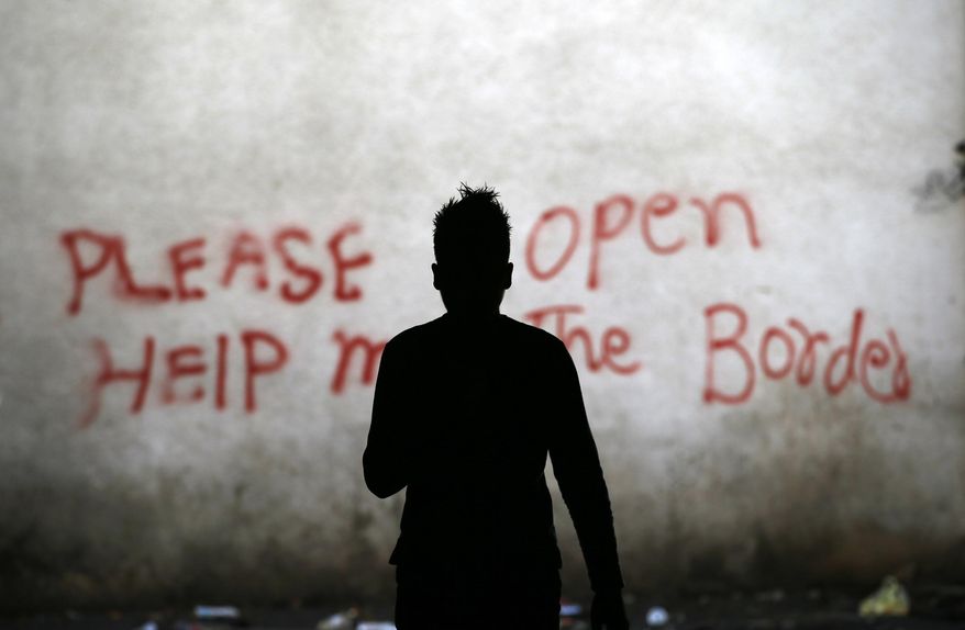 A migrant walks through an abandoned warehouse that has served as a make-shift shelter for hundreds of men trying to reach Western Europe, in Belgrade, Serbia, Tuesday, March 21, 2017. Thousands of migrants have been stranded in Serbia looking for ways to reach western Europe. Many have tried several times to cross to Hungary or Croatia. (AP Photo/Darko Vojinovic)