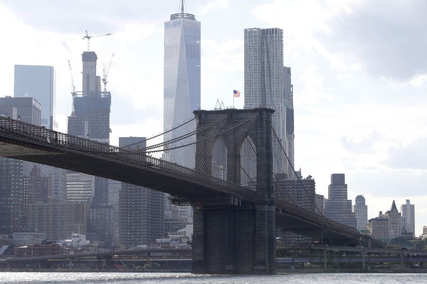 FILE - In this June 30, 2016 file photo, the Brooklyn Bridge spans the East River from Brooklyn into Manhattan, as seen from Brooklyn Bridge Park, in New York. The Department of Justice has taken the rare step of seeking to strip a convicted terrorist, Iyman Faris, 47, of his U.S. citizenship as he serves the last several years of a 20-year prison sentence for plotting to destroy New York's Brooklyn Bridge. Some national security experts suggested Tuesday, March 21, 2017, the move might signal a new, tougher line under President Donald Trump. (AP Photo/Kathy Willens, File)