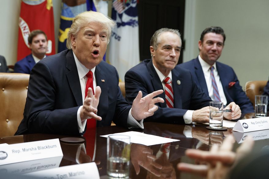 FILE - In this Feb. 16, 2017 file photo, President Donald Trump, accompanied by Rep. Chris Collins, R-N.Y., speaks in the Roosevelt Room of the White House in Washington. House Republican leaders want to shift more than $2 billion in Medicaid costs from upstate counties to the New York State government. The provision would help mostly Republican-controlled counties that have struggled to subsidize Medicaid payments for the poor. New York City wouldn’t get the same relief. (AP Photo/Evan Vucci, File)