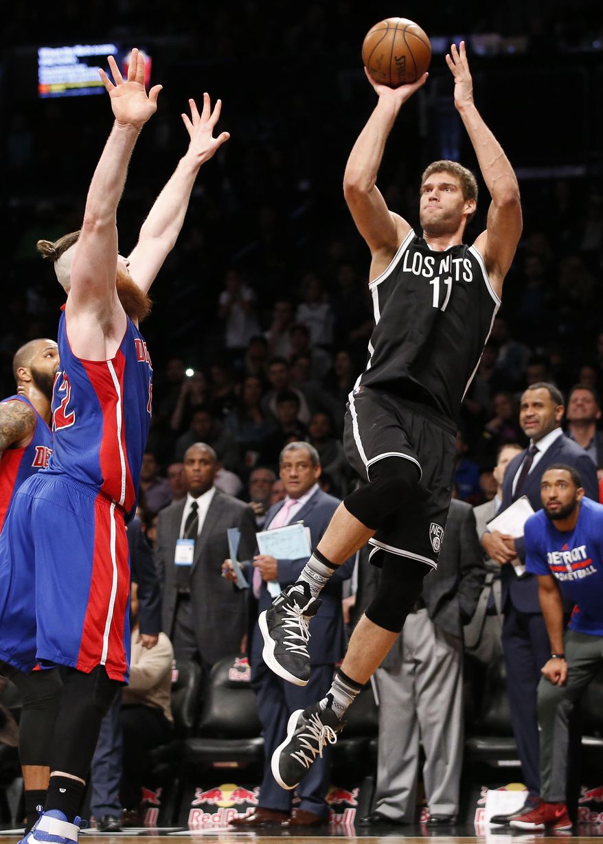 Detroit Pistons center Aron Baynes (12) defends as Brooklyn Nets center Brook Lopez (11) goes up for two points to sink a buzzer-beater that lifted the Nets to victory over the Pistons during the second half of an NBA basketball game, Tuesday, March 21, 2017, in New York. The Nets defeated the Pistons 98-96. (AP Photo/Kathy Willens)