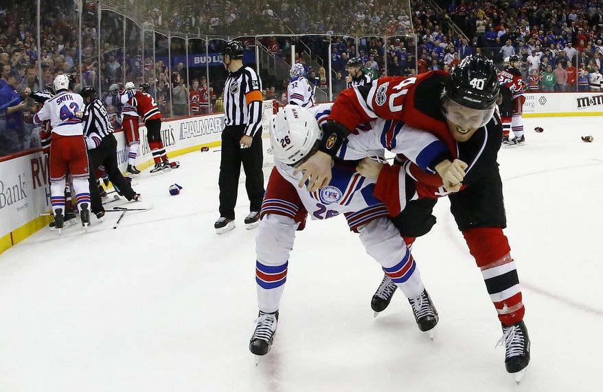 New Jersey Devils&#39; Blake Coleman (40) and New York Rangers left wing Jimmy Vesey (26) fight each other while teammates engage in their own fights during the second period of an NHL hockey game, Tuesday, March 21, 2017, in Newark, N.J. (AP Photo/Julio Cortez)