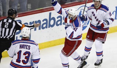 New York Rangers right wing Rick Nash (61) celebrates with teammates Kevin Hayes (13) and J.T. Miller (10) after scoring a goal on the New Jersey Devils during the third period of an NHL hockey game Tuesday, March 21, 2017, in Newark, N.J. (AP Photo/Julio Cortez)