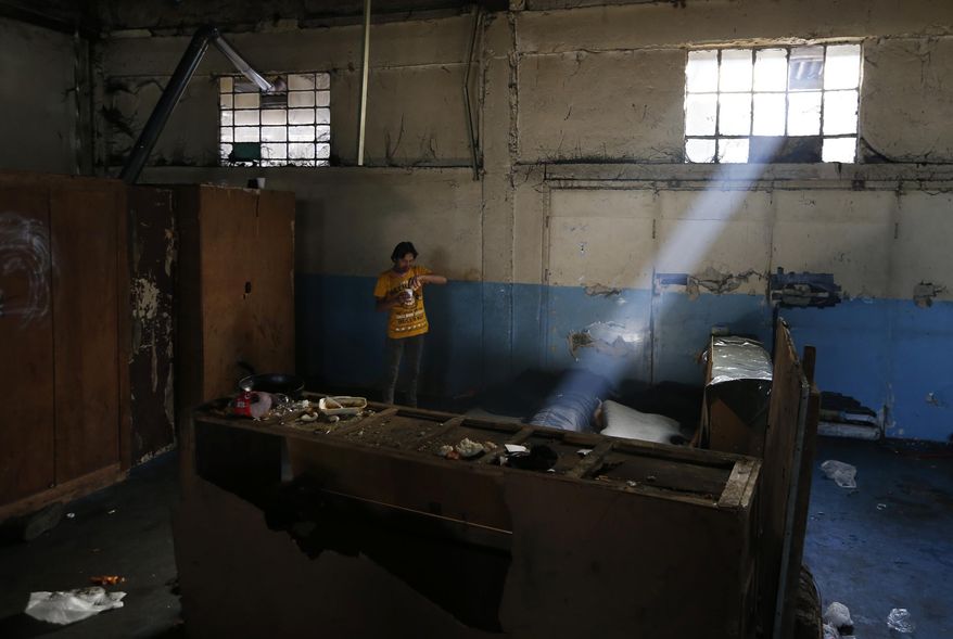 A man rests in an abandoned warehouse that has served as a make-shift shelter for hundreds of migrants trying to reach western Europe, in Belgrade, Serbia, Tuesday, March 21, 2017. Thousands of migrants have been stranded in Serbia looking for ways to reach western Europe. Many have tried several times to cross to Hungary or Croatia. (AP Photo/Darko Vojinovic)