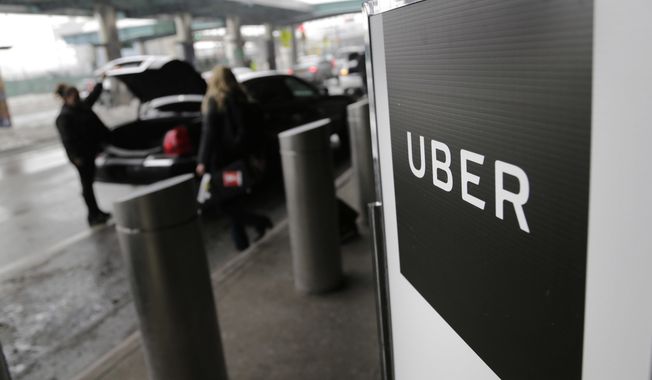 File- In this March 15, 2017, file photo, a sign marks a pick-up point for the Uber car service at LaGuardia Airport in New York. Uber is vowing to head down a new road and become a more humane company. The promise made in a conference call with reporters Tuesday, March 21, 2017, comes amid a wave of ugly developments, including allegations of rampant sexual harassment and a video of a profanity-laced confrontation between the ride-hailing company&#x27;s CEO and a disgruntled driver.  (AP Photo/Seth Wenig, File)