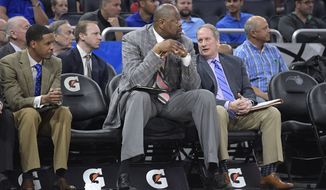 Charlotte Hornets assistant coach Patrick Ewing, center, watches from the bench during the second half of an NBA basketball game against the Orlando Magic in Orlando, Fla., Wednesday, March 22, 2017. The Hornets won 109-102. (AP Photo/Phelan M. Ebenhack)