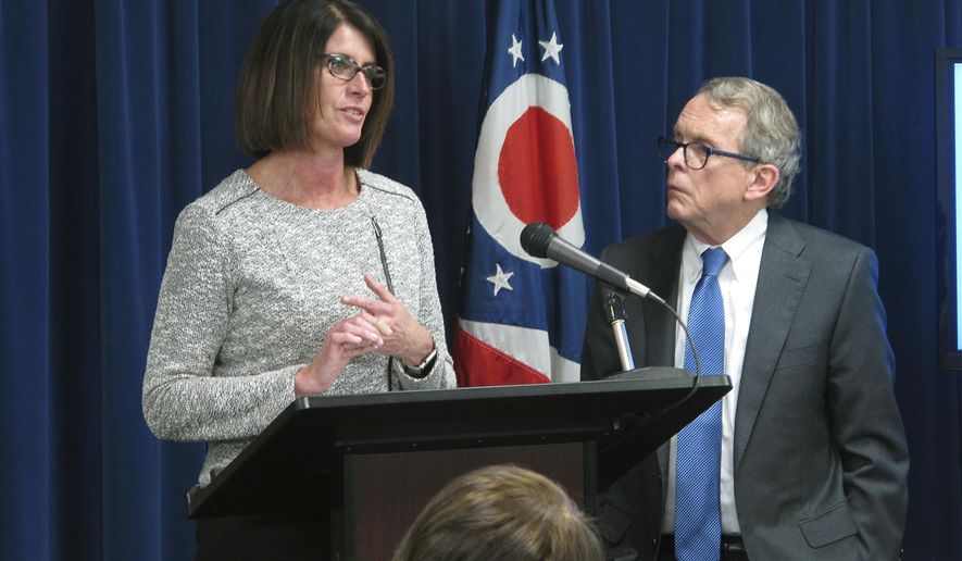 Angela Sausser, left, executive director of the Public Children Services Association of Ohio, discusses a $3.6 million pilot program to help children hurt by their parents' addiction to painkillers and heroin, during a news conference where Ohio Attorney General Mike DeWine, right, announced the initiative Wednesday, March 22, 2017, in Columbus, Ohio. The pilot program targets 14 southern Ohio counties hit hard by the state's opiate epidemic. (AP Photo/Andrew Welsh-Huggins)