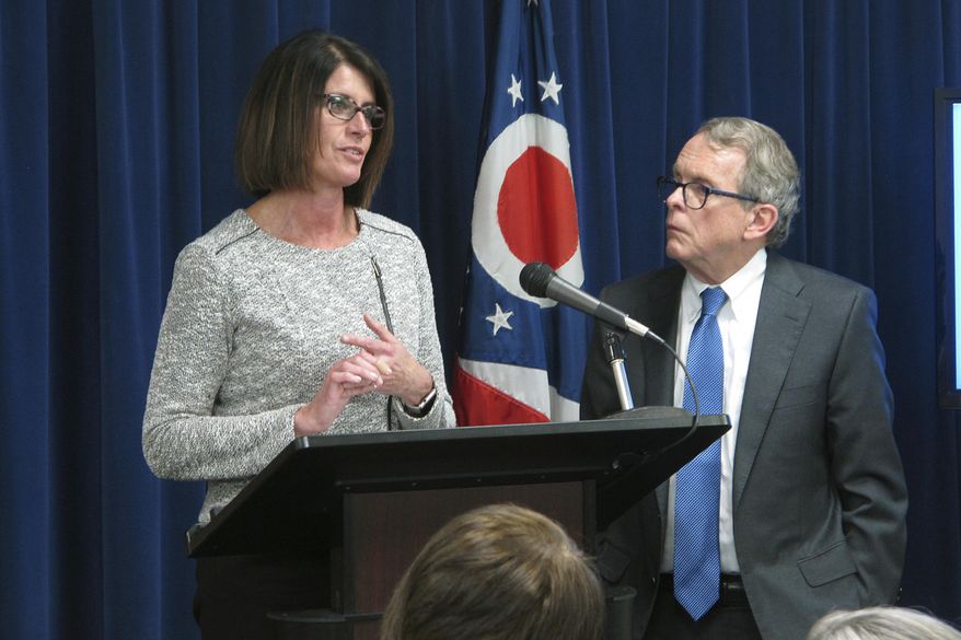 Angela Sausser, left, executive director of the Public Children Services Association of Ohio, discusses a $3.6 million pilot program to help children hurt by their parents' addiction to painkillers and heroin, during a news conference where Ohio Attorney General Mike DeWine, right, announced the initiative Wednesday, March 22, 2017, in Columbus, Ohio. The pilot program targets 14 southern Ohio counties hit hard by the state's opiate epidemic. (AP Photo/Andrew Welsh-Huggins)