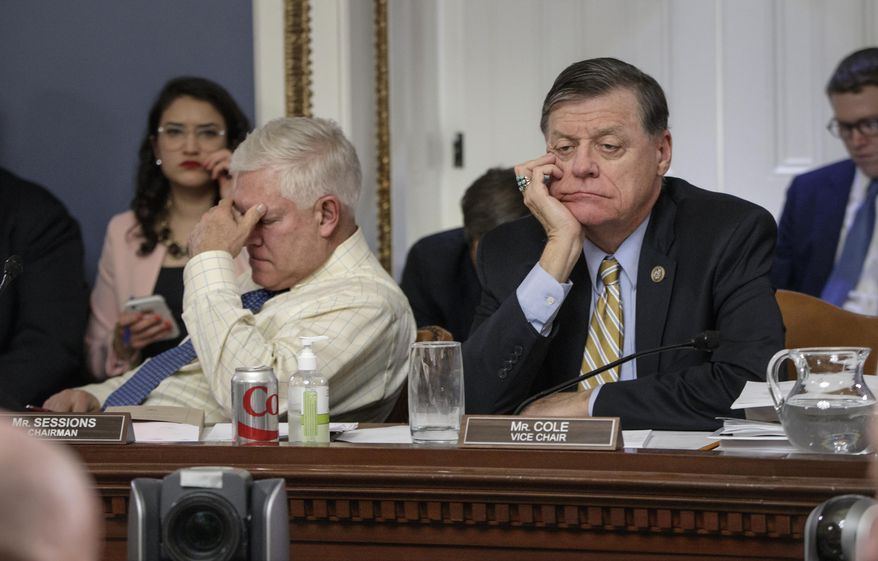 After eight hours of debate, House Rules Committee Chairman Rep. Pete Sessions, R-Texas, left, and Rep. Tom Cole, R-Okla., the vice-chair, listen to arguments from committee chairs as the panel meets to shape the final version of the Republican health care bill before it goes to the floor for debate and a vote, Wednesday, March 22, 2017, on Capitol Hill in Washington. (AP Photo/J. Scott Applewhite)