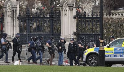 Armed police officers enter the Houses of Parliament in London, Wednesday, March 23, 2017 after the House of Commons sitting was suspended as witnesses reported sounds like gunfire outside.(AP Photo/Kirsty Wigglesworth)