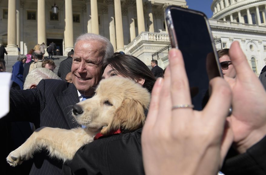 Former Vice President Joe Biden poses for a photo as he greets the crowd on Capitol Hill in Washington, Wednesday, March 22, 2017, following an even marking seven years since former President Barack Obama signed the Affordable Care Act into law. (AP Photo/Susan Walsh)