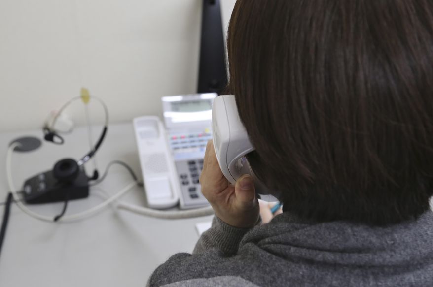 In this March 15, 2017 photo, a staff of "Inochinodenwa," non-profit telephone hotline for people seek help, receives a counseling call in Tokyo. Fewer Japanese are taking their own lives, a glimmer of hope in a country with one of the world’s highest suicide rates. The number of suicides has dropped for seven straight years in a clear indication of a downward trend. The Health Ministry said Thursday, March 23, 2017, that 21,897 people committed suicide in 2016, down from more than 30,000 in 2011. (AP Photo/Koji Sasahara)