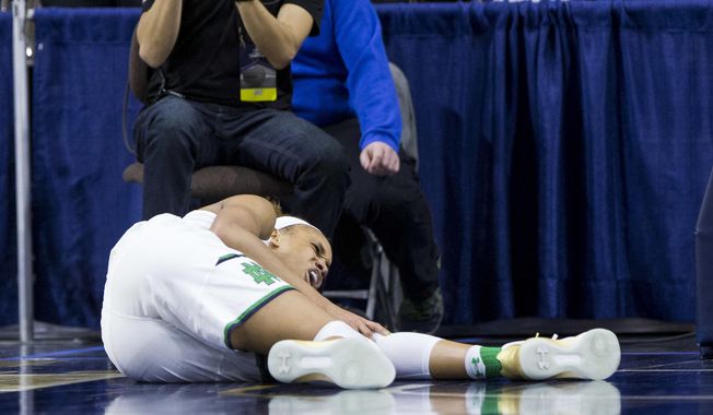 FILE - In this Sunday, March 19, 2017, file photo, Notre Dame's Brianna Turner reacts to a knee injury during the first half of a second-round game against Purdue in the NCAA college basketball tournament in South Bend, Ind. Top-seeded Notre Dame tries to prepare for its Sweet 16 game against Ohio State after losing leading scorer Brianna Turner for the season and with Kathryn Westbeld hobbling on a bad ankle.  (AP Photo/Robert Franklin, File)