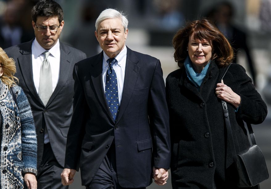 Former Penn State president Graham Spanier, with wife Sandra, walks back from a lunch break on the second day of his trial at the Dauphin County Courthouse, Tuesday, March 21, 2017, in Harrisburg, Pa. The failure of Penn State's former president to report child molestation accusations against Jerry Sandusky allowed evil "to run wild," prosecutors said Tuesday at the start of Spanier's trial. (Dan Gleiter/PennLive.com via AP)