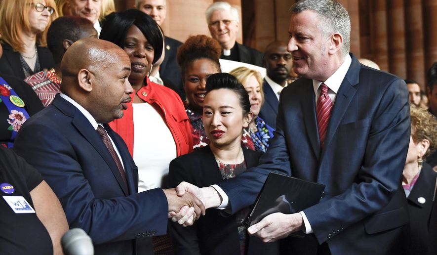 New York Assembly Speaker Carl Heastie, left, greets New York City Mayor Bill de Blasio as lawmakers and community groups urge New York Gov. Cuomo and the State Senate majority to join the State Assembly in supporting fair-share tax policies on billionaires and millionaires in this year's budge during a news conference at the Capitol on Wednesday, March 22, 2017, in Albany, N.Y. (AP Photo/Hans Pennink)