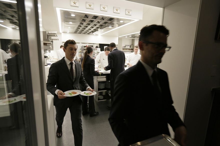 n this photo taken Thursday, March 9, 2017, servers leave the kitchen and make their way to the dining room at the French Laundry restaurant in Yountville, Calif. Celebrated chef Thomas Keller has just opened a state-of-the art new kitchen at his famed French Laundry after spending $10 million on an extensive renovation. (AP Photo/Eric Risberg)