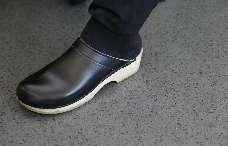 In this photo taken Thursday, March 9, 2017, chef Thomas Keller wears a clog while standing on a terrazzo floor inside the new kitchen at the French Laundry restaurant in Yountville, Calif. The celebrated chef Keller has just opened a state-of-the art new kitchen at his famed French Laundry after spending $10 million on an extensive renovation. The floor was described as slip-proof and seamless with no grout lines to prevent bacteria. (AP Photo/Eric Risberg)
