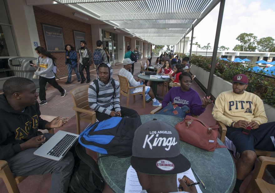 File - In this Oct. 22, 2012 file photo, college students study outdoors at the California State University, Long Beach in Long Beach, Calif. California State University's governing board will vote Wednesday, March 22, 2017, on whether to raise tuition for the first time in six years. The nation's largest public university system says it needs to hire more faculty and add more classes to accommodate growing enrollment and insufficient state funding. (AP Photo/Damian Dovarganes, File)