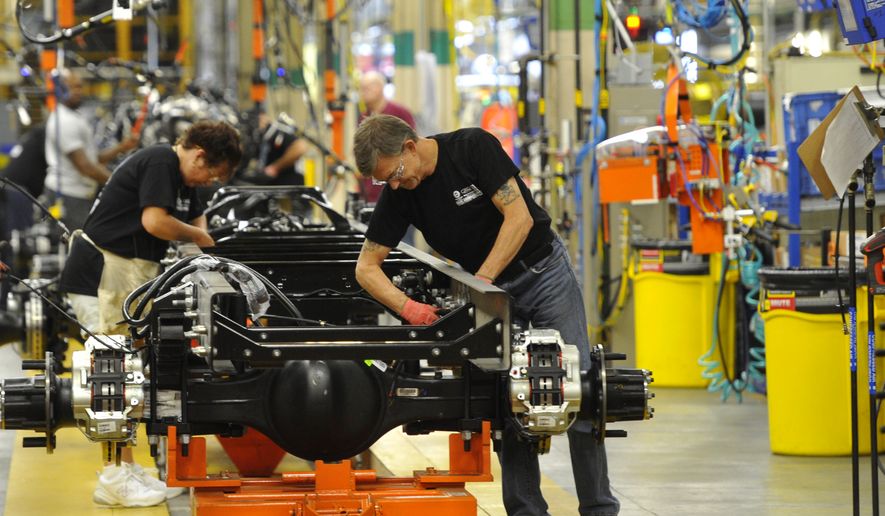 In this photo taken Aug. 12, 2015, workers assemble a truck at Ford Motor Company&amp;#8217;s Ohio Assembly Plant Wednesday, Aug. 12, in Avon Lake, Ohio. The United Auto Workers union on Friday, Nob. 6, 2015, has reached a tentative contract agreement with Ford. The contract covers 53,000 workers at 22 U.S. plants.  (AP Photo/David Richard)