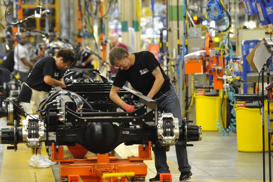 In this photo taken Aug. 12, 2015, workers assemble a truck at Ford Motor Company&amp;#8217;s Ohio Assembly Plant Wednesday, Aug. 12, in Avon Lake, Ohio. The United Auto Workers union on Friday, Nob. 6, 2015, has reached a tentative contract agreement with Ford. The contract covers 53,000 workers at 22 U.S. plants.  (AP Photo/David Richard)