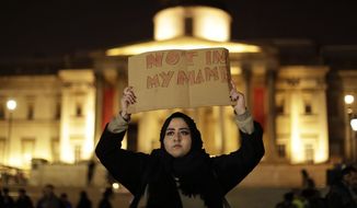 A woman holds up a sign at a vigil for the victims of Wednesday&#39;s attack, at Trafalgar Square in London, Thursday, March 23, 2017. The Islamic State group has claimed responsibility for an attack by a man who plowed an SUV into pedestrians and then stabbed a police officer to death on the grounds of Britain&#39;s Parliament. Mayor Sadiq Khan called for Londoners to attend a candlelit vigil at Trafalgar Square on Thursday evening in solidarity with the victims and their families and to show that London remains united. (AP Photo/Matt Dunham)