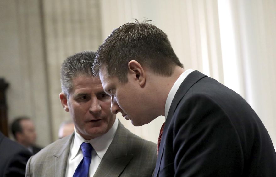Former Chicago Police Officer Jason Van Dyke, right, confers with his attorney Dan Herbert as they attend a hearing in front of Judge Vincent Gaughan at the Leighton Criminal Courts Building Thursday, March 23, 2017 in Chicago. A grand jury has added 16 counts of aggravated battery with a firearm to the first-degree murder charges against Van Dyke, accused in the 2014 fatal shooting of a black 17-year-old. (Nancy Stone/Chicago Tribune via AP, Pool)