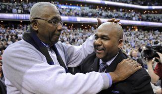 FILE - In this March 9, 2013, file photo, former Georgetown coach John Thompson Jr., left, congratulates his son Georgetown head coach John Thompson III, right, after the Hoya&#x27;s 61-39 win over Syracuse in an NCAA college basketball game in Washington.  Georgetown has fired basketball coach John Thompson III on Thursday, March 23, 2017, after two consecutive losing seasons at the school his father led to a national championship. (AP Photo/Nick Wass, File) **FILE**