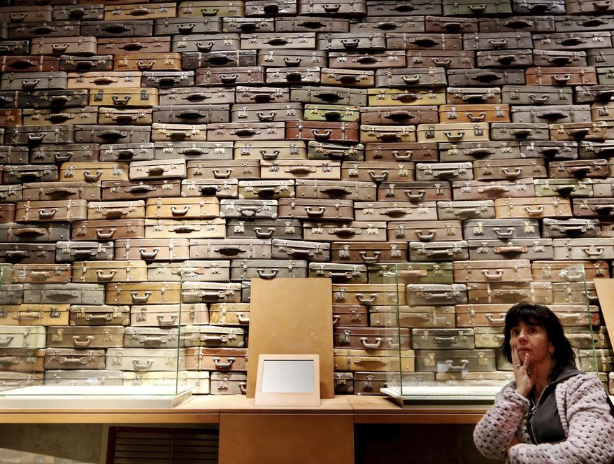 FILE -In this file photo taken in Gdansk, Poland, Jan. 23, 2017, a woman looks at an exhibit in the Museum of the Second World War, an ambitious new museum under creation for nine years, that opened its doors then for one day to historians and reporters. It opened to visitors on Thursday, March 23, 2017, amid plans by the conservative government to change its content to fit its nationalist views. (AP Photo/Czarek Sokolowski, File)